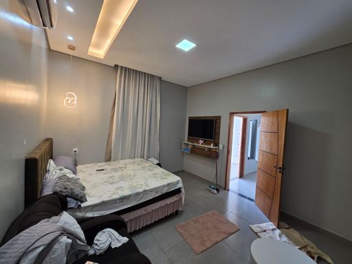 Quarto amplo e confortável em casa no bairro Conceição, zona sul de Porto Velho, com piso em porcelanato, iluminação de teto e bom espaço para cama e mobiliário.