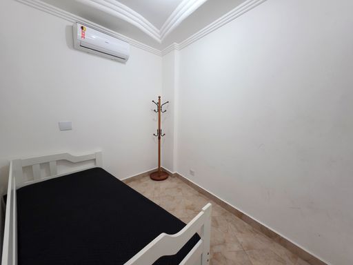 Dormitório com cama de solteiro.

Quarto branco com cama de solteiro preta e ar-condicionado.

Este dormitório aposta no minimalismo, com paredes brancas que ampliam o espaço reduzido. A cama de solteiro possui cabeceira branca e enxoval preto, harmonizando com o piso cerâmico em tons terrosos claros. Um mancebo de madeira serve como cabideiro funcional no canto do quarto. A iluminação é suave e o teto possui acabamento em moldura de gesso. Equipado com ar-condicionado, o quarto oferece uma sensação térmica de repouso e tranquilidade absoluta.