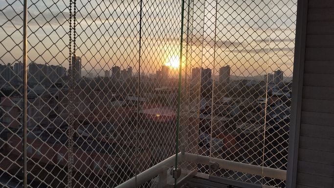 vista livre e privilegiada do pôr do sol da varanda gourmet envidraçada