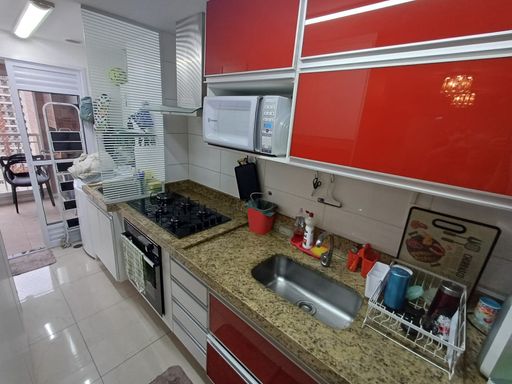 cozinha com armários planejados de primeira qualidade e ampla pia em granito, semi integrada a área de serviço com acesso a varanda gourmet