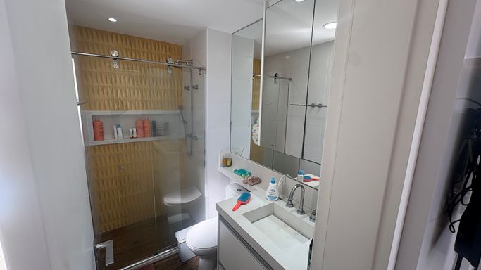 Banheiro da suíte com box de vidro e nicho em total requinte