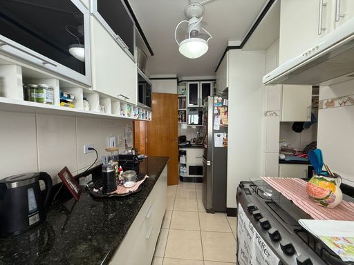 cozinha arejada com planejados, semi integrada a área de serviço com porta de correr