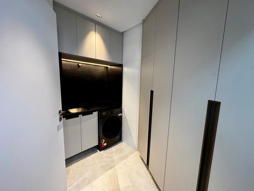 área de serviço com armários planejados e pia ampla em granito preta