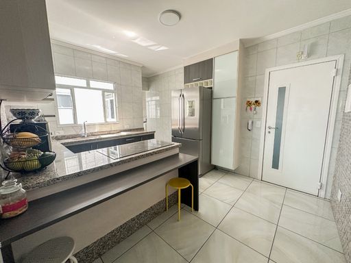 cozinha padrão americana impecável com armários planejados, bem iluminada