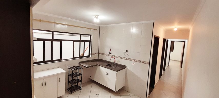 cozinha bem arejada com ampla janela e armários planejados, com acesso aos dormitórios