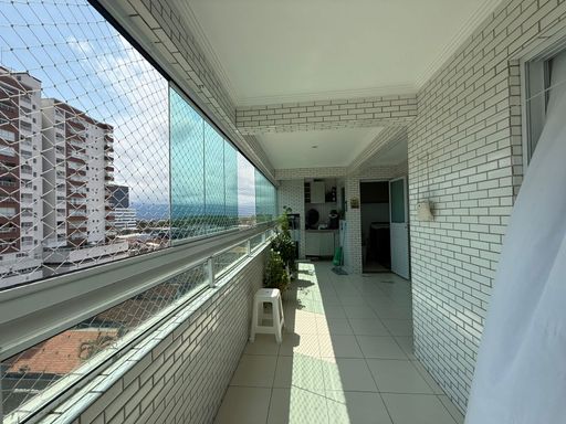 ampla varanda gourmet envidraçada com churrasqueira a carvão, tela de proteção e vista livre