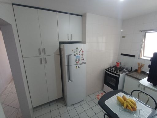 ampla cozinha bem arejada com armários planejados