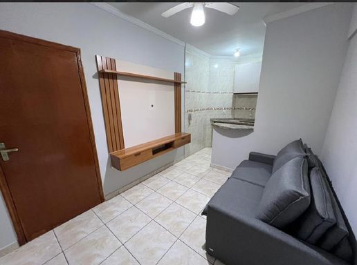 Sala semi integrada a cozinha com balcão em granito
