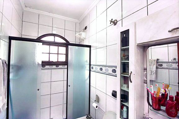 banheiro da suíte bem arejado com box de vidro