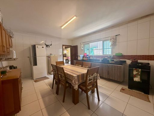 cozinha com armários planejados bem arejada com ampla pia em granito preta