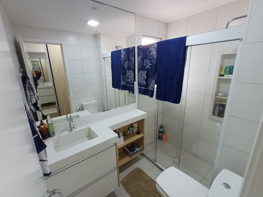 amplo banheiro da suíte com armário planejado e box blindex