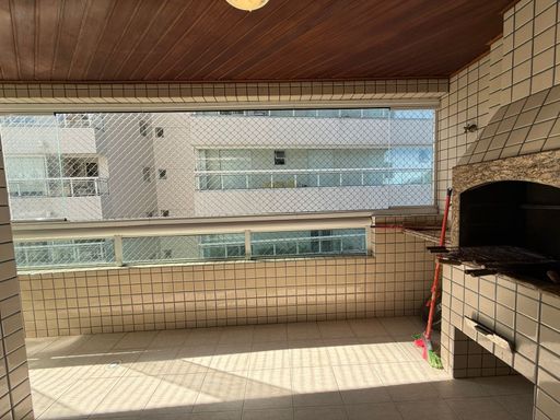 varanda gourmet envidraçada com vista para o morro do Xixová, churrasqueira a carvão e tela de proteção