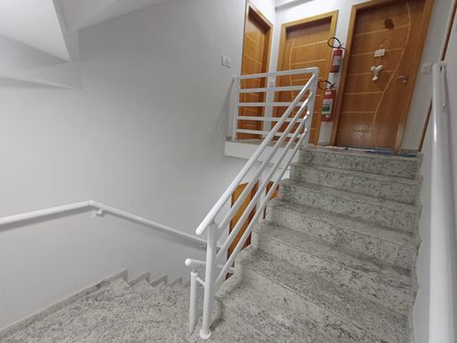 escada de acesso ao apartamento em granito com portas trabalhadas em melhor padrão