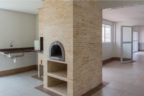 área gourmet com churrasqueira a carvão e forno de pizza