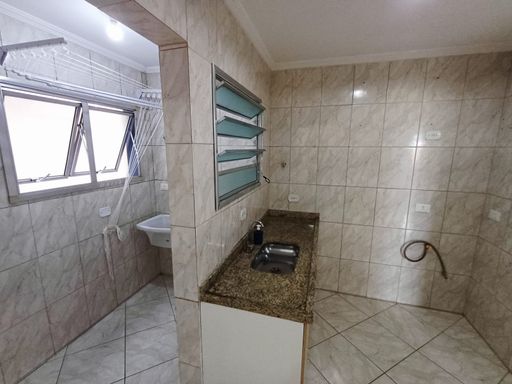 cozinha semi integrada com a área de serviço bem arejada