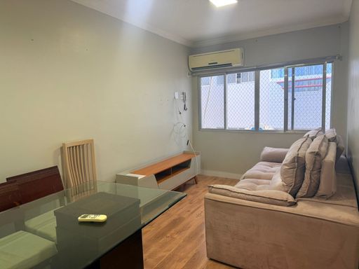 Sala de 2 ambientes com uma mesa de jantar, sofá, ventilador de teto e ar-condicionado.