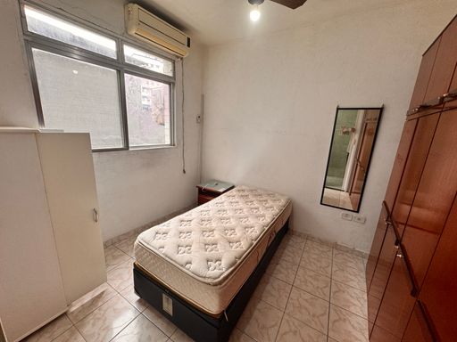 Dormitório bem iluminado com ar-condicionado.