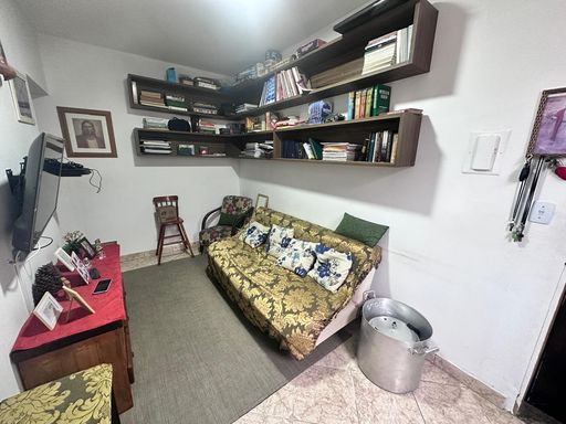Sala espaçosa com sofá cama e nichos na parede.