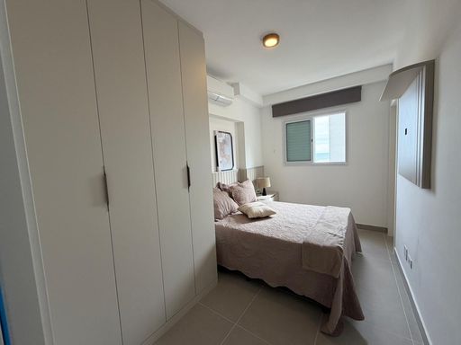 Suíte planejada com ar-condicionado e uma cama de casal.