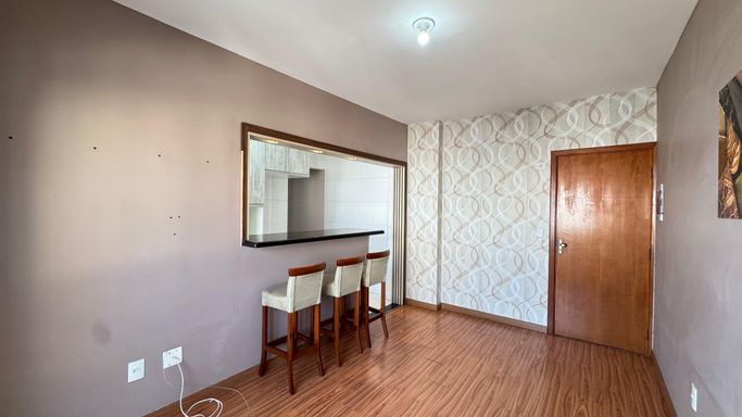 Sala espaçosa com muita iluminação natural, piso laminado, ar-condicionado e acesso a sacada.