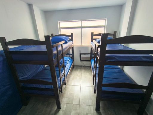 Sala living bem iluminada com ventilador de teto.