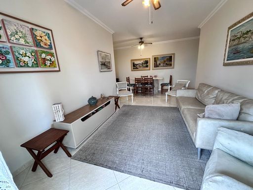 Sala ampla e bem iluminada de dois ambientes com mesa de jantar e dois ventilador de teto.