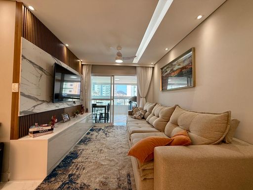 Sala ampla de 2 ambientes com mesa de jantar e um sofá.