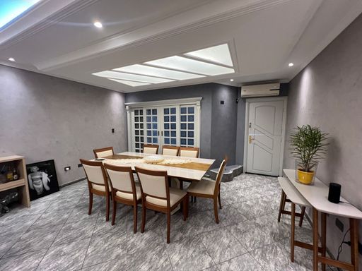 Sala ampla de 2 ambientes com teto rebaixado em gesso com iluminação em LED.