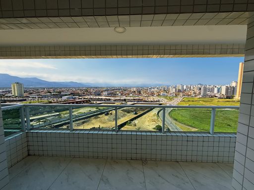 Sacada gourmet com ponto de gás e vista para o mar.