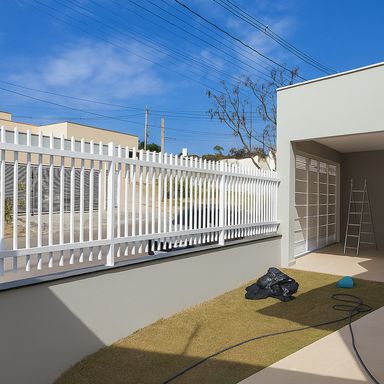 Fachada moderna com portão branco e paisagismo frontal