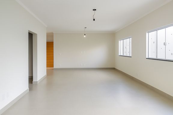 Sala ampla e arejada com piso claro e excelente iluminação natural
