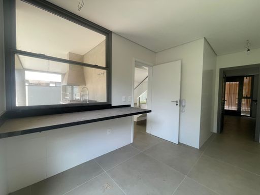 A fluidez dos ambientes integrados, revelando a conexão perfeita entre a cozinha e a sala de estar, ideal para quem ama receber.